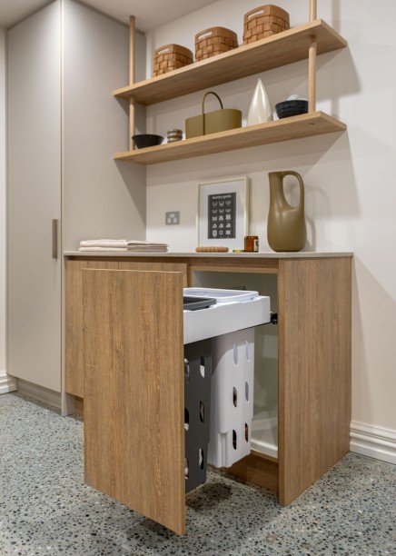 basement laundry with integrated laundry hampers in view